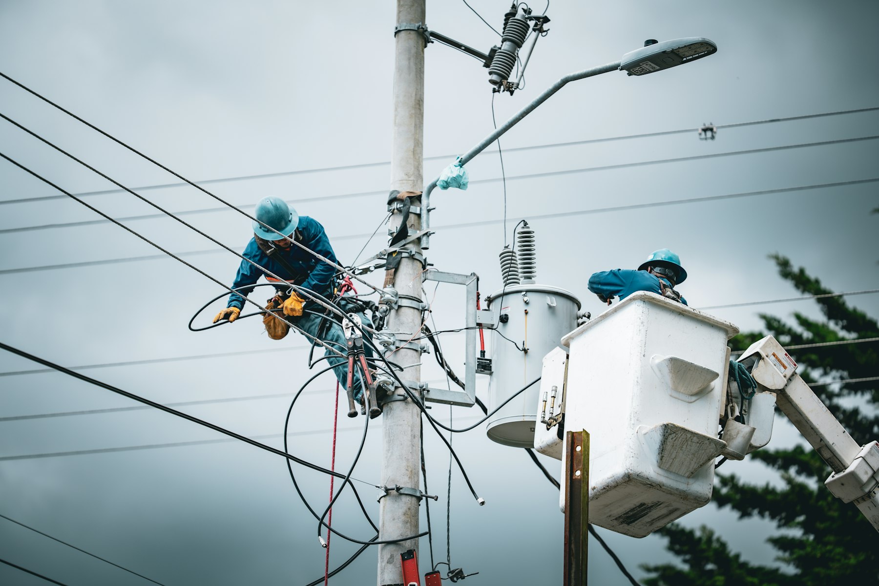 Lineman lashing fiber to an aerial strand