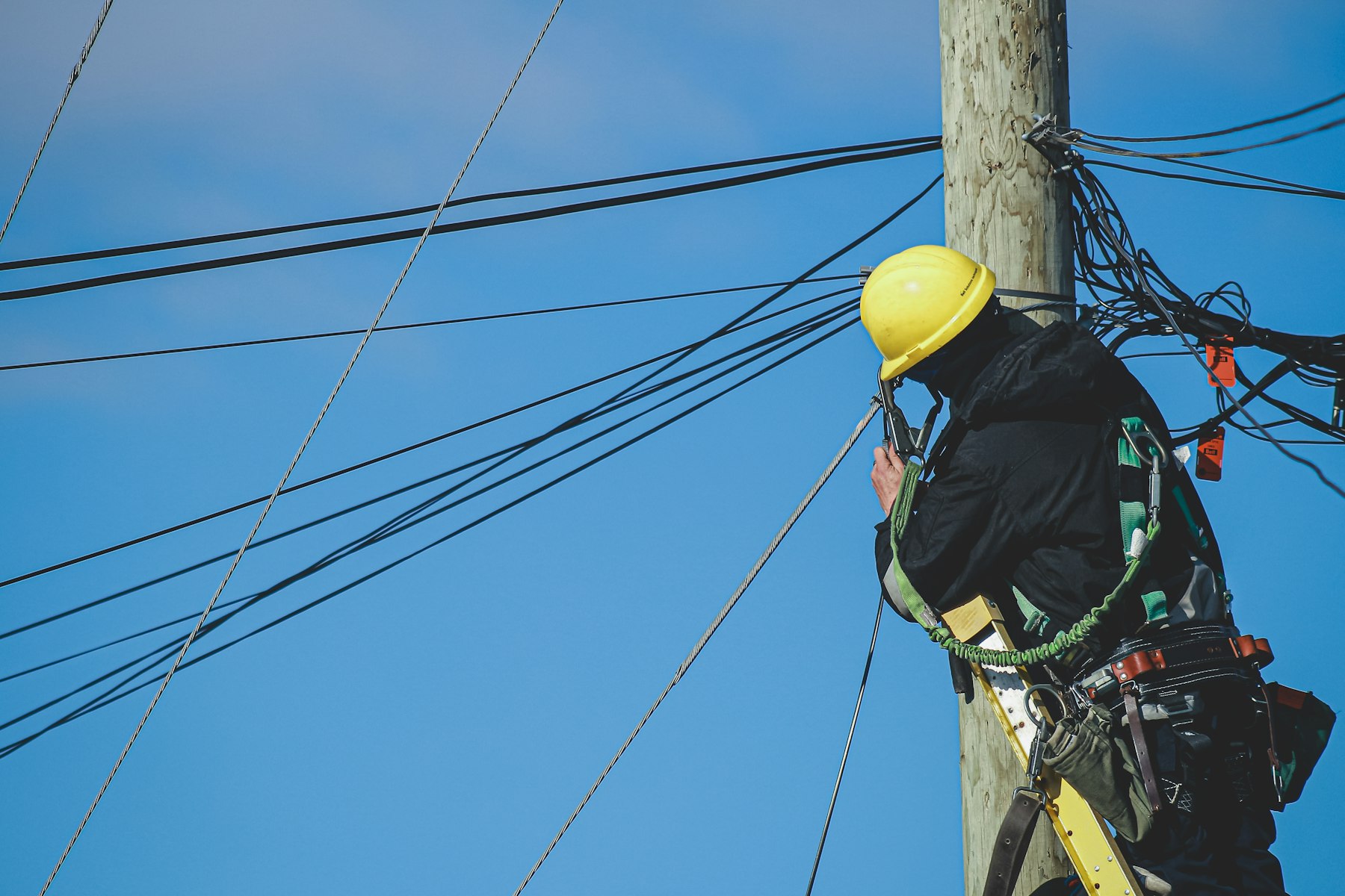 ConLit technician working aerial plant in full fall protection